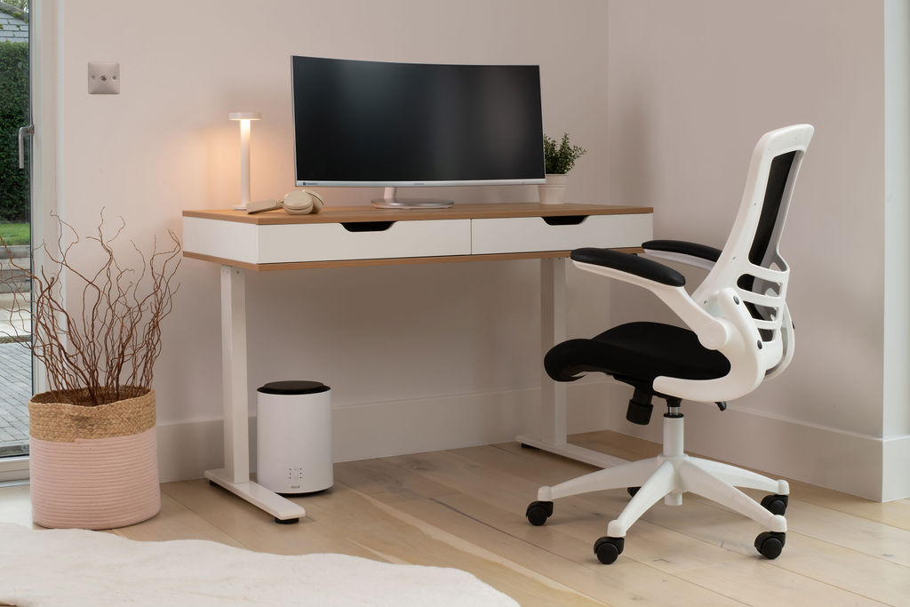 A complete home office set-up with a white and maple height adjustable desk and a white and black office chair. 