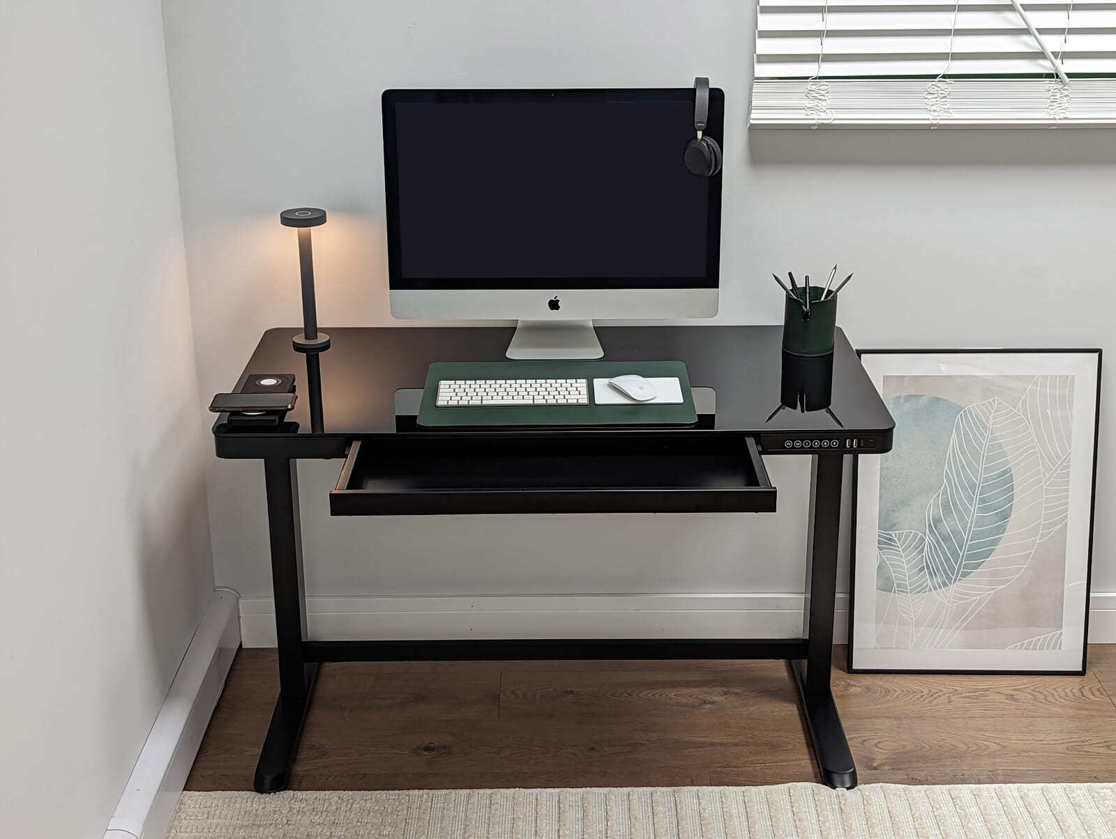 The Oskar Height Adjustable Desk from Koble Designs, a retro design with a mahogany effect desktop and black frame finish. Sit or stand at your chosen height from 75cm to 125cm. Technical features include 4 memory settings, 1 USB port, and 1 USB-C port.